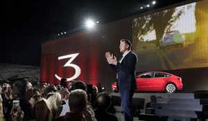 Man on stage presenting electric vehicle  