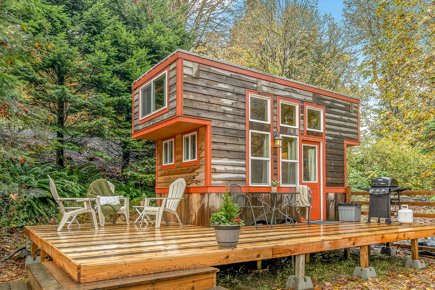 tiny house with deck and chairs
