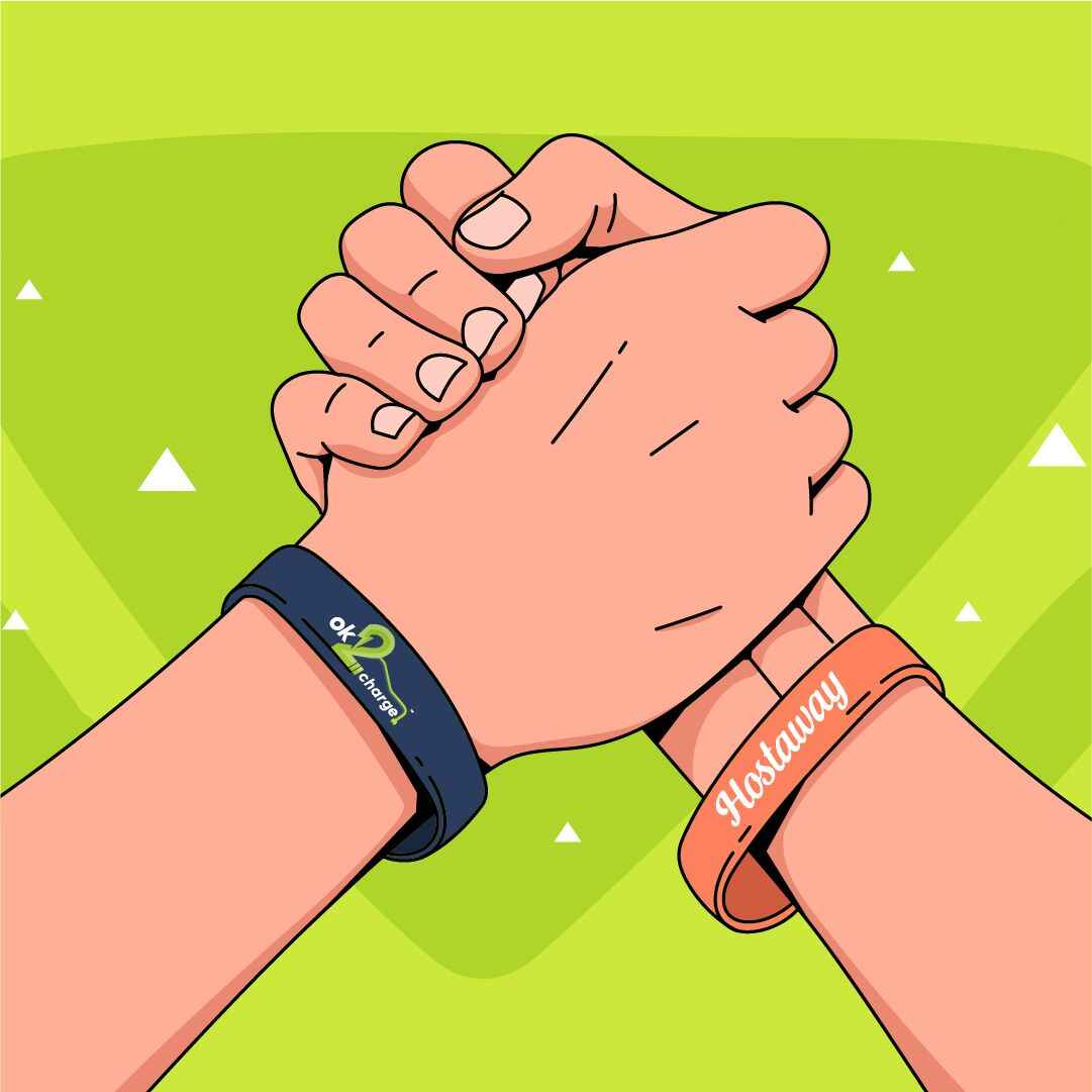 Two hands clasping against green background