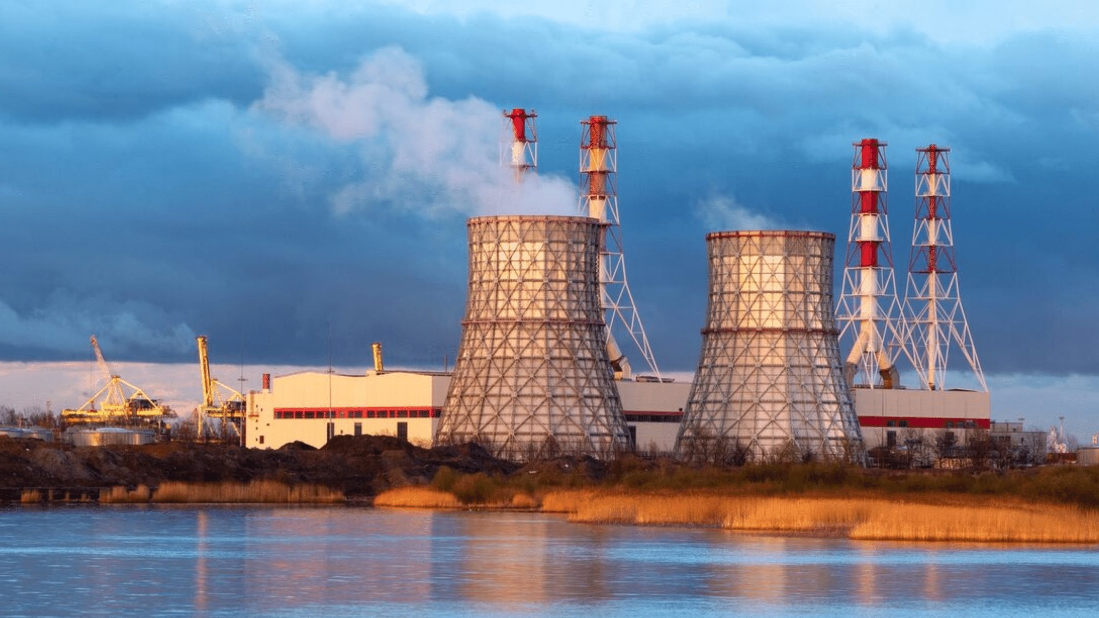 Factory buildings burning coal against skyline 